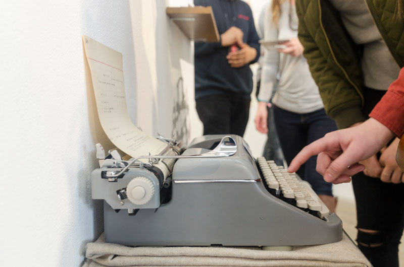 People typing on a typewriter